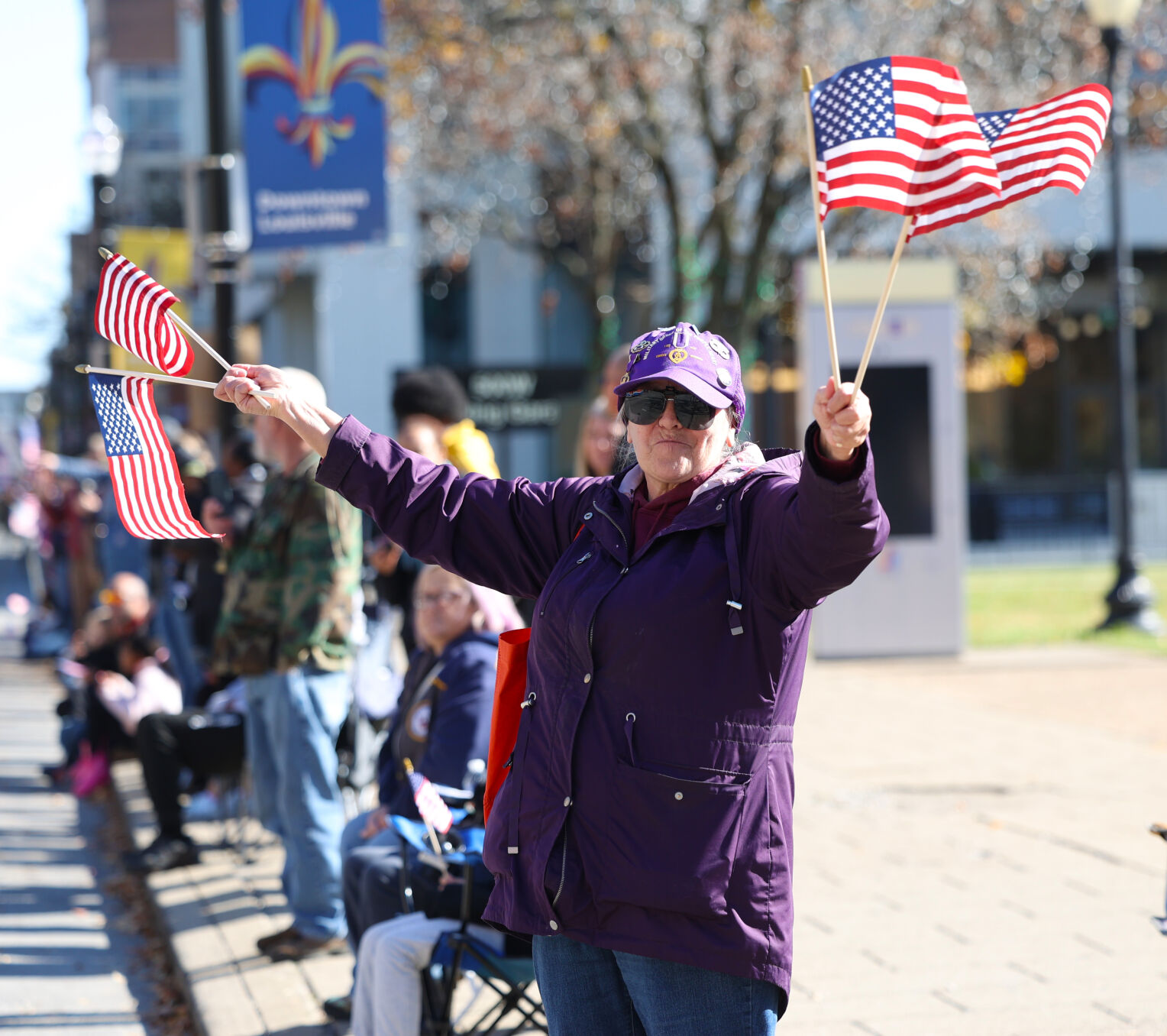 Woman waves flags at parade.JPG